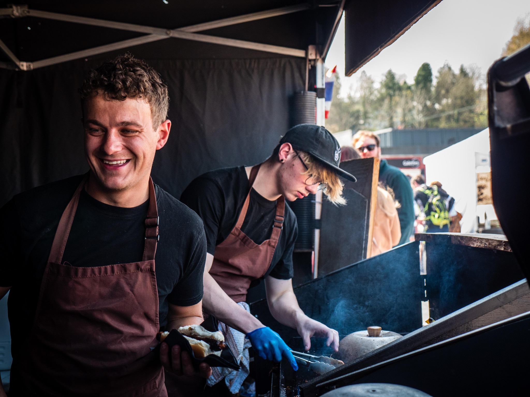 Alex and Luke cooking at event